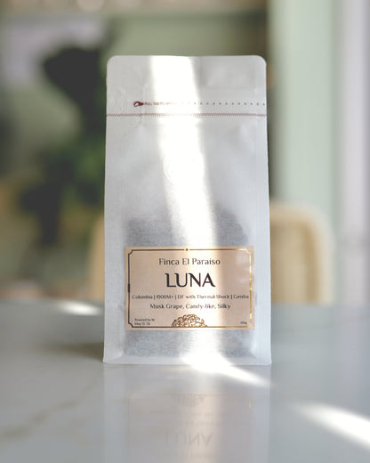 Luna coffee research release, whole bean bag, labeled 'LUNA' and  'Finca El Paraíso' on a blurred background